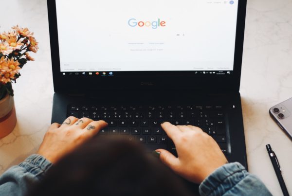 Woman at laptop accessing Google