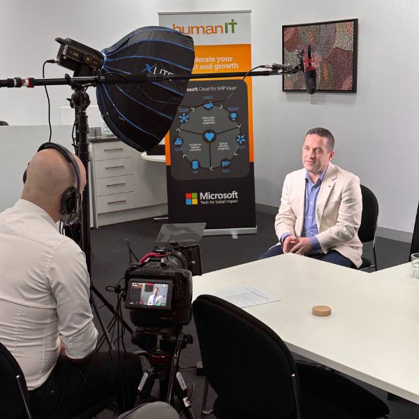 Behind the scenes photo of Ian from humanIT being interviewed on camera.