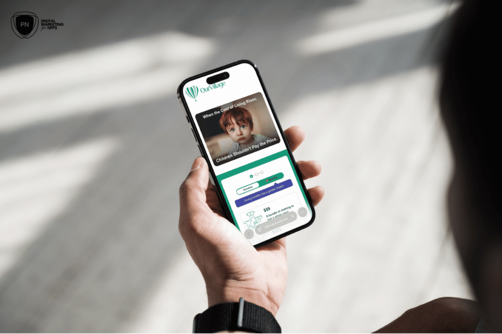 Person holding phone with campaign page visible on the screen.