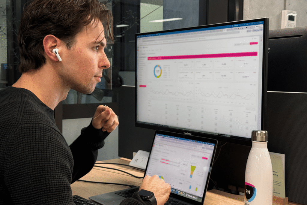 Man reviewing reporting dashboard on a computer screen.
