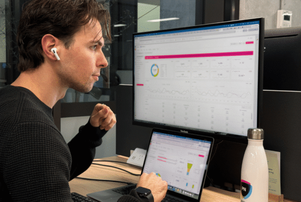 Man reviewing reporting dashboard on a computer screen.