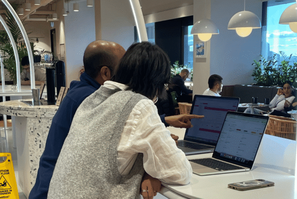 Two people looking at laptop screens